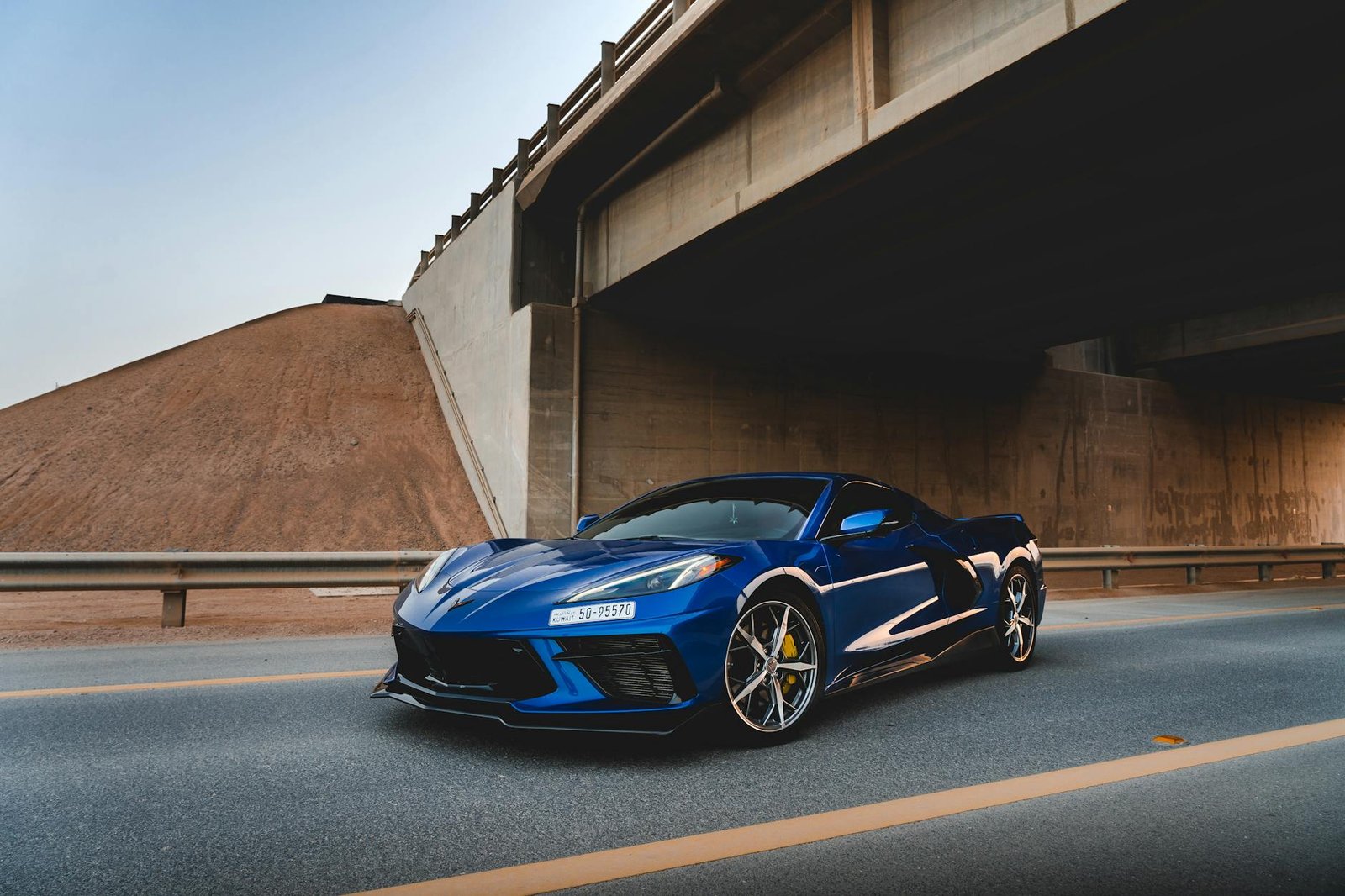 photo of blue corvette parked on asphalt road
