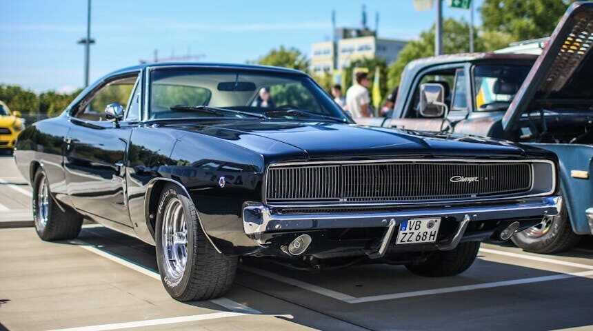 parked black muscle car in the parking lot