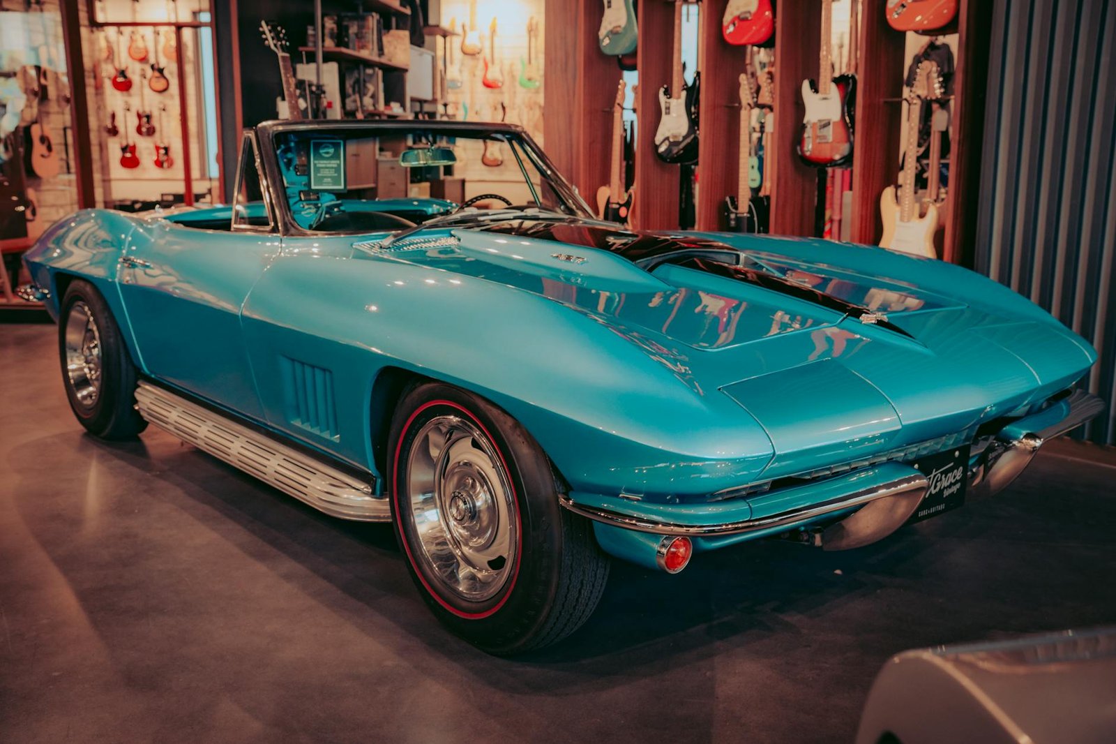 blue chevrolet car parked inside a guitar store