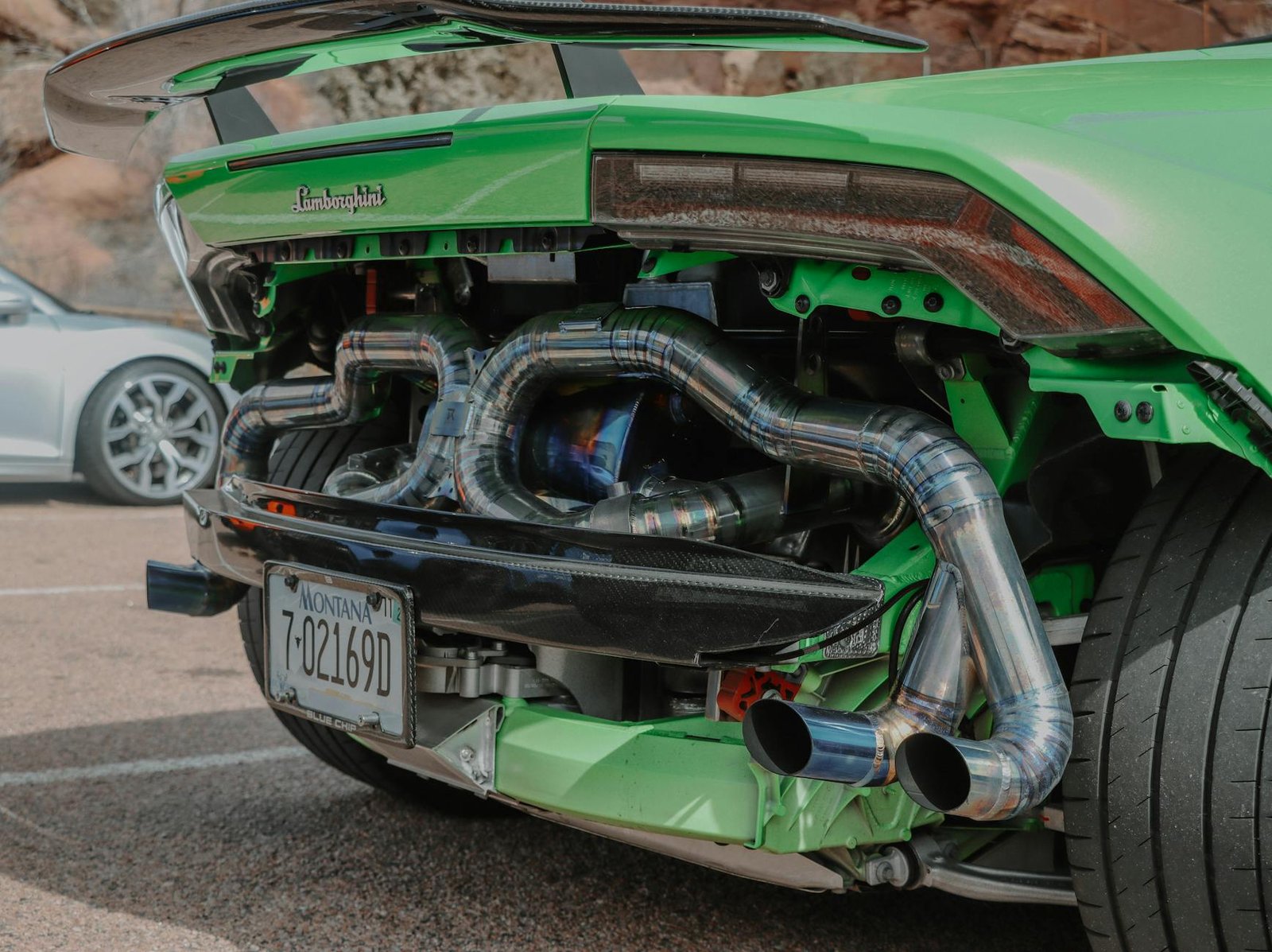 close up of the built under the rear bumper in a green lamborghini huracan