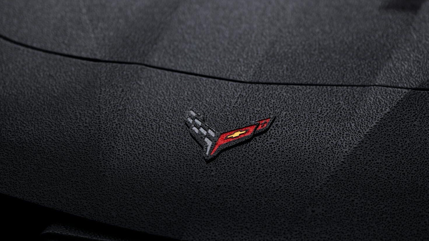 close up of emblem on black chevrolet corvette